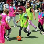 Kids break in the new futsal court of opening day of the Legacy Square. Photo by Drew Dotson.