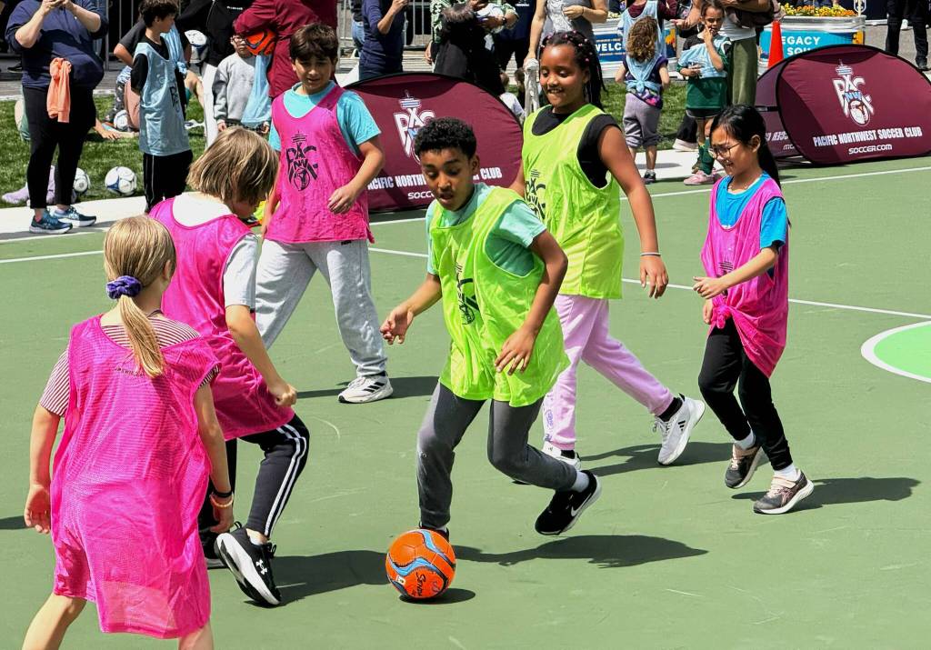 Kids break in the new futsal court of opening day of the Legacy Square. Photo by Drew Dotson.