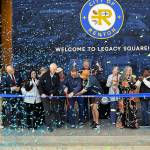 Renton Mayor Armondo Pavone cuts the ribbon for the Legacy Square alongside retired Seattle Sounders player Brad Evans. Photo by Drew Dotson/Sound Publishing.